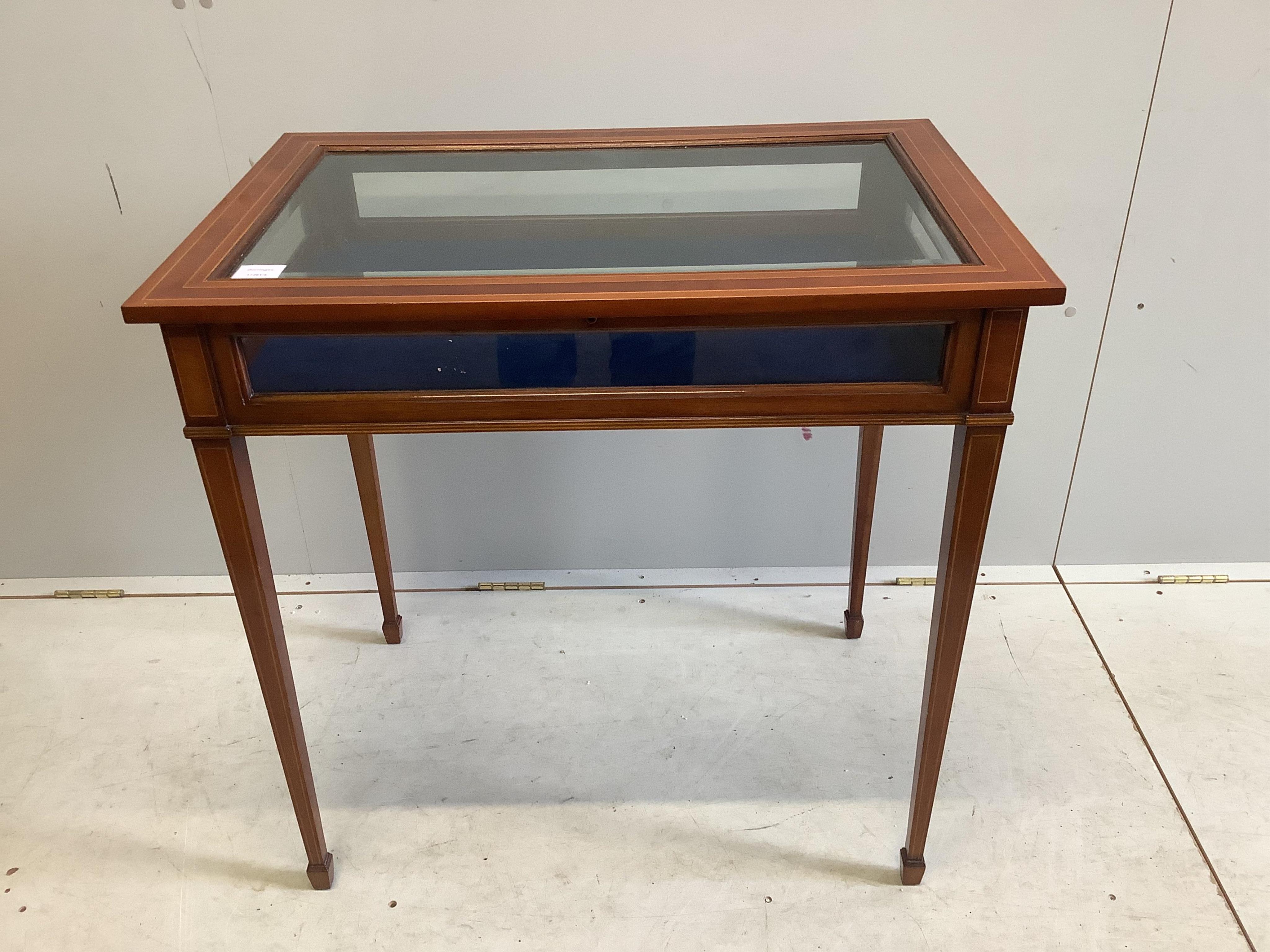 A reproduction inlaid mahogany bijouterie table, width 77cm, depth 52cm, height 76cm. Condition - good